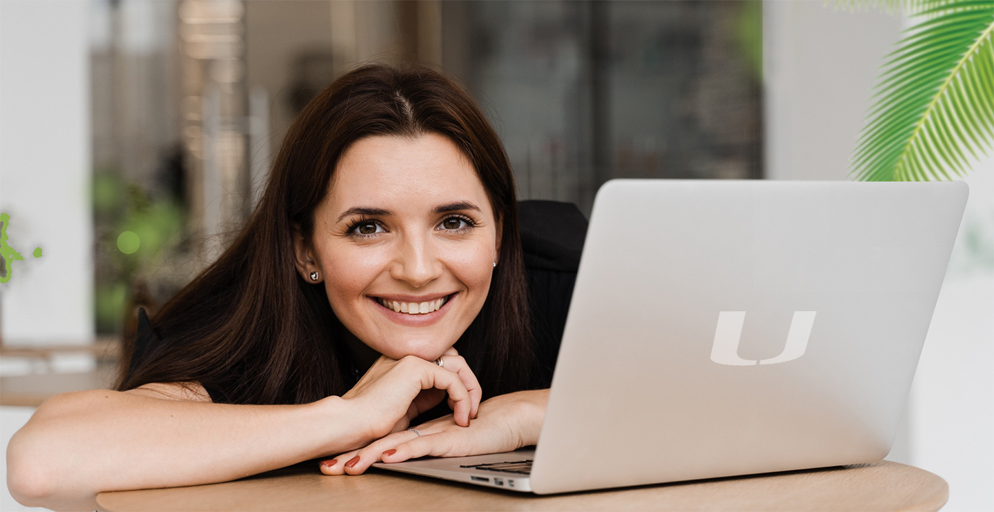 Smiling woman with open laptop
